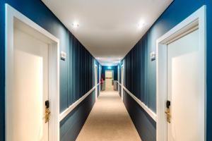 a hallway with blue walls and two doors at Velamar Boutique Hotel - Adults Friendly in Albufeira