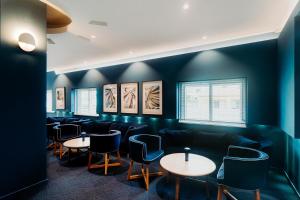 a restaurant with blue walls and tables and chairs at Velamar Boutique Hotel - Adults Friendly in Albufeira