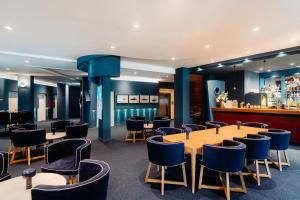 a restaurant with tables and chairs and a bar at Velamar Boutique Hotel - Adults Friendly in Albufeira