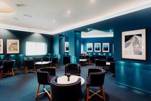 a room with blue walls and tables and chairs at Velamar Boutique Hotel - Adults Friendly in Albufeira