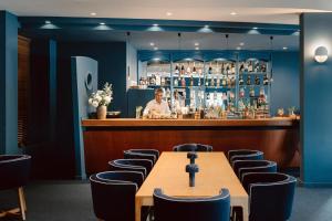 a bar with a wooden table and chairs at Velamar Boutique Hotel - Adults Friendly in Albufeira