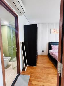 a bathroom with a bed and a glass shower at Vortex Suites Klcc 2bedroom & 3bedroom apartment in Kuala Lumpur