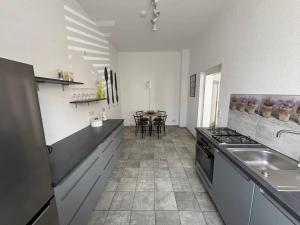 a kitchen with a sink and a stove top oven at Ferienwohnung Gubener Neißeglück 23 in Guben +6 photos