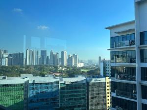 a view of a city skyline with tall buildings at Modern and Slick Condo in Venice near Makati and BGC in Sampong