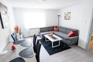 a living room with a couch and a table at Apartman 11 in Tomislavgrad