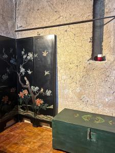 a black cabinet with flowers and birds painted on it at Puleera Boutique Hotel in Giarre +90 photos