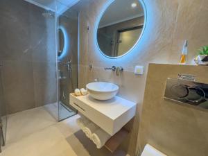 a bathroom with a sink and a mirror at Luxury Rooms Naoum - Adults only in Limenaria +48 photos
