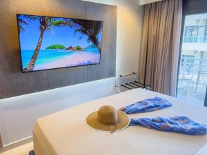 a hat on a bed in a hotel room at Luxury Rooms Naoum - Adults only in Limenaria