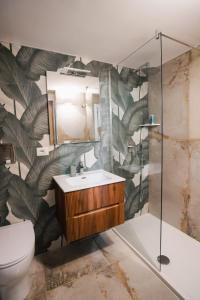 a bathroom with a toilet and a sink and a mirror at B&B Riccioli D'oro in Margherita di Savoia