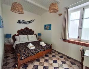 a bedroom with a bed with two towels on it at VFH Villa Flavia Eco B&B - 50 metri dal mare in Santa Flavia