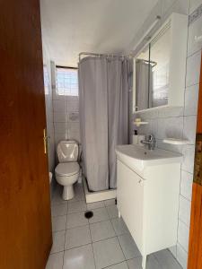 a white bathroom with a toilet and a sink at Ianthi House in Néa Thésis +28 photos