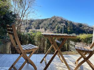 a wooden table and two chairs on a patio at Kamakura Jomyoji Terrace-鎌倉浄明寺テラス- in Kamakura +107 photos