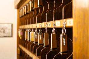 a row of wine bottles hanging on a wall at Hotel Rossmann in Greifenburg