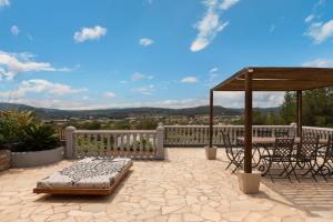 a patio with a table and a gazebo at Villa Beni - Santa Eulalia in Santa Eularia des Riu