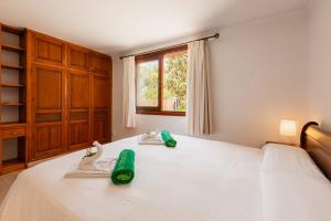 a bedroom with a large white bed with two slippers at Villa Beni - Santa Eulalia in Santa Eularia des Riu +24 photos