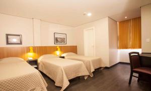 Postel nebo postele na pokoji v ubytování Hotel Grand Barão
