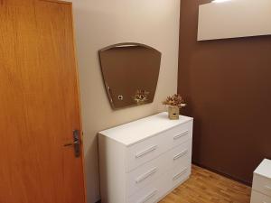 a bathroom with a white dresser and a mirror at Casa Sinetta Como Lake in Acquaseria +50 photos