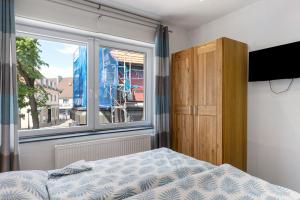 a bedroom with a bed and a window at Ferienwohnung Möckmühl in Möckmühl +27 photos