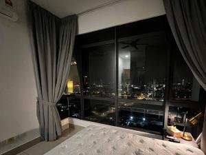 a bedroom with a large window with a city view at KL Sky Condo - Top Floor in Kuala Lumpur +10 photos