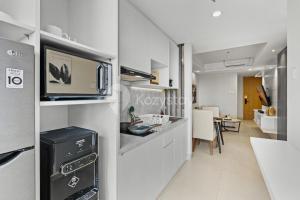 Una cocina con microondas y un comedor. en Alva by Kozystay - Nusa Dua, en Nusa Dua