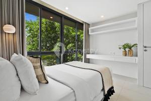 Un dormitorio con una cama y una ventana grande. en Alva by Kozystay - Nusa Dua, en Nusa Dua 20 fotos más