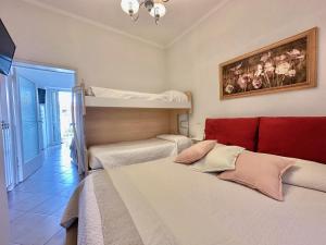 A bed or beds in a room at Beach House Gelsomino