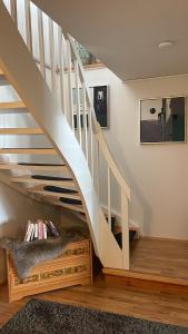 a staircase in a living room with a dog bed under it at La Casa Senja in Håverjorda
