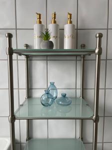 a glass shelf in a bathroom with two bowls and cups at La Casa Senja in Håverjorda +95 photos