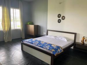 a bedroom with a bed and a window at BH Sunrise Villa Yercaud in Yercaud