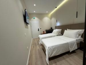 Postel nebo postele na pokoji v ubytování Rooms at Mimosa Street