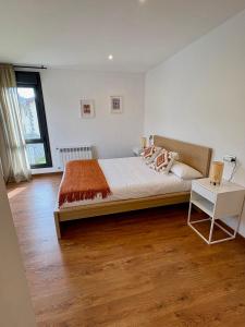 a bedroom with a large bed and a table at Casa El Lloréu in Naves
