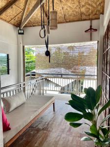 a living room with a couch and a large window at Sun & Surf Hostel - STARLINK in Santa Monica