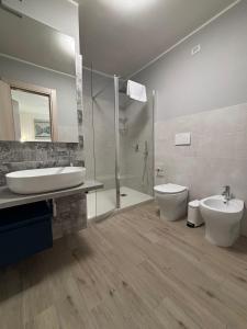 a bathroom with a sink and a toilet and a shower at le suite dell'isola in Oliveri +34 photos