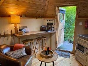 a living room with a bar in a tiny house at Woodmans Huts in Haverthwaite