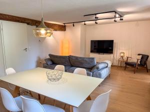 a living room with a table and a couch at Ferienwohnung Ava No4 - 4 Gäste in Altheim