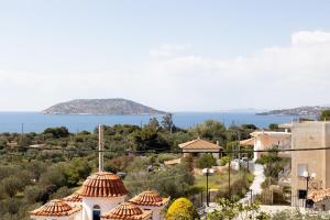 a view of a small island in the water at Aethra Villa in Sounio