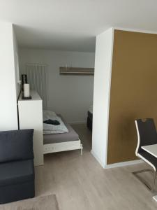 a living room with a bed and a chair at -NEUE- Ferienwohnung - Monteurwohnung in Lippe in Lage