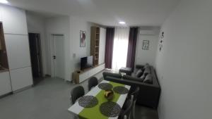 a living room with a table and a couch at Golem Horizon apartment in Golem