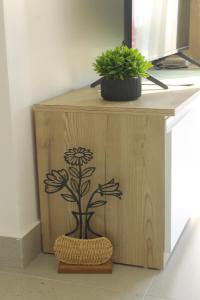 a wooden cabinet with a flower stencil on it at Golem Horizon apartment in Golem