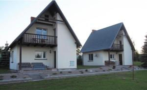 a large white house with a gambrel roof at Agroturystyka Iwona Jażdżewska in Osława Dąbrowa