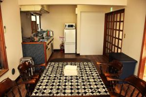 a kitchen with a table and chairs and a refrigerator at Traditional Japanese House -in Matsumoto Asama Onsen- in Matsumoto +31 photos
