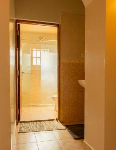 a bathroom with a shower and a toilet at Gatundu Slow Life Farm Stay and Hiking in Tea Farms in Kangunyi