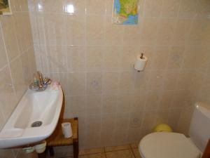 a bathroom with a sink and a toilet at L'Azeuil in Saint-Vidal
