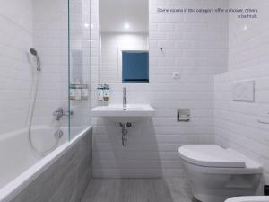 a bathroom with a toilet and a sink and a shower at Numa Prague Root in Prague