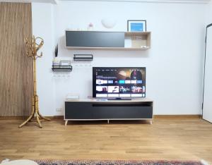 a living room with a flat screen tv on a wall at VM Ravenna Luxury Apartment in Ravenna