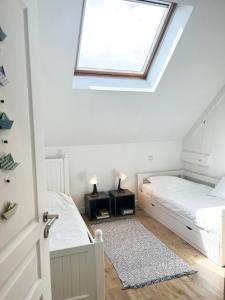 a bedroom with two beds and a window at L'échappée belle in Luc-sur-Mer