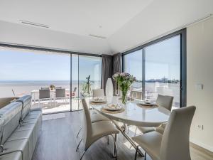a dining room with a white table and chairs at Luxury Penthouse Pedro - The View Fuengirola in Fuengirola