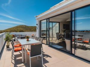 a balcony with a table and chairs at Luxury Penthouse Pedro - The View Fuengirola in Fuengirola