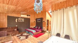 a bedroom with a bed in a wooden room at Himalayan Outskirt Cottages & Tree house in Jibhi