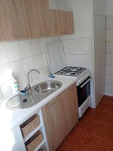 a small kitchen with a sink and a stove at Staszica Centrum in Lublin +10 photos